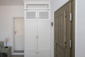 アエギアリにあるPetradi Studios & Villaの白いクローゼット(窓、ドア付)