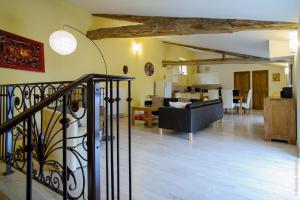 a living room with a staircase and a living room at La Bégude D'Amalthée in Vernay +26 photos