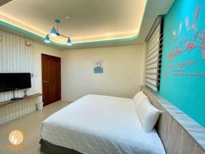 TV a/nebo společenská místnost v ubytování Ta Lang Guan Hai Mei Su B&B