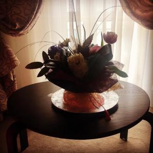 a vase filled with flowers on top of a table at Hotel Corsa in Mangalia