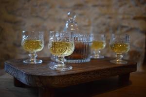 a group of wine glasses on a wooden table at Latmos 1860 in Skala