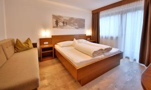 Postel nebo postele na pokoji v ubytování Hotel Garni Fiegl Apart