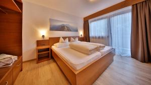 Postel nebo postele na pokoji v ubytování Hotel Garni Fiegl Apart