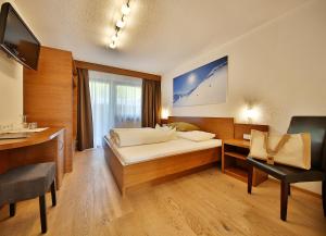 Postel nebo postele na pokoji v ubytování Hotel Garni Fiegl Apart