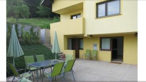 a patio with a table and chairs and a building at Apartament Tatiana in Rogaška Slatina