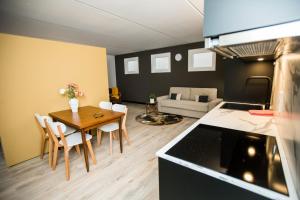 a kitchen and living room with a table and chairs at appartement - sauna - natuur - Utrecht in Soest