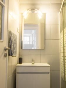 a bathroom with a sink and a mirror at Alagoa Terrace Guesthouse in Faro