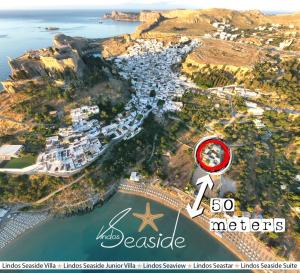 an aerial view of a harbor with a house and the ocean at Lindos SeaStar Apartment in Lindos