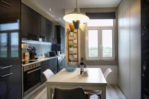 a kitchen with a table and chairs and a window at Expo Oriente 2 Bedrooms by GT House in Lisbon