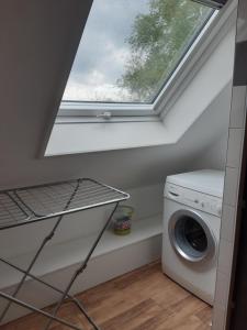 a laundry room with a window and a washing machine at Auf dem Lande in Weener