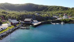 an aerial view of a harbor with boats in the water at Adventure Senja in Skrollsvika