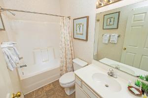 a bathroom with a sink and a toilet and a shower at River Oaks Golf Resort in Myrtle Beach