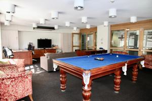 a living room with a pool table in it at Mariners Court Hotel Sydney in Sydney