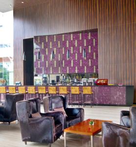 a lobby with chairs and a bar in a restaurant at Crowne Plaza Guangzhou Huadu, an IHG Hotel - Free shuttle bus to Baiyun airport in Guangzhou