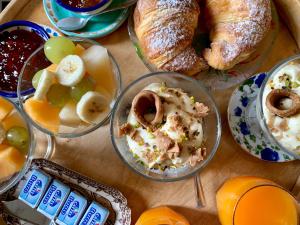 a table topped with bowls of food and bread at Villino Eleonora in Parghelia