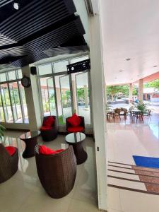 a lobby with chairs and tables in a building at Better Place Hotel in Ubon Ratchathani