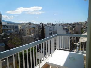 a balcony with a table and a view of a city at Jacuzzi Suites in Thessaloniki