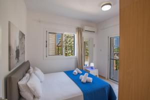 a bedroom with a bed with two towels on it at Jason Villas in Protaras +40 photos