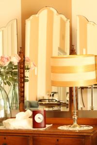 a lamp on a dresser in front of a mirror at The Lighthouse Guesthouse in Colesberg