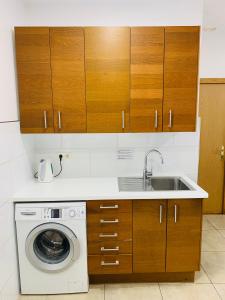 a kitchen with a sink and a washing machine at Super Balmes Guest House in Barcelona +90 photos