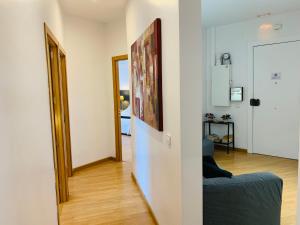 a living room with a blue couch and a mirror at Super Balmes Guest House in Barcelona