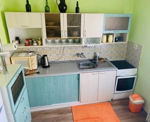 a small kitchen with white cabinets and a sink at Ubytování NOVÁ in Kunžak
