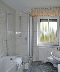 a bathroom with a tub and a sink at Ferienwohnung Bergblick Xanten in Xanten