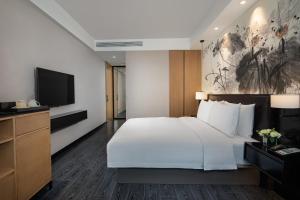Postel nebo postele na pokoji v ubytování Fuzhou Mawei Yiho Hotel