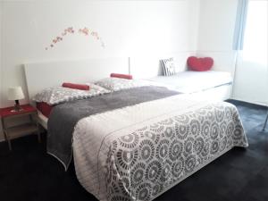 a bedroom with two beds and a window at Apartmány Karlštejn in Karlštejn