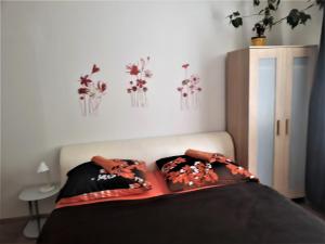 a bedroom with a bed with flowers on the wall at Apartmány Karlštejn in Karlštejn