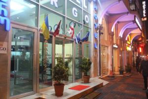 a store front with potted plants in front of a building at Hotel Argo in Batumi