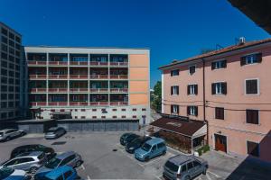 a parking lot with cars parked in front of a building at House365 in Koper