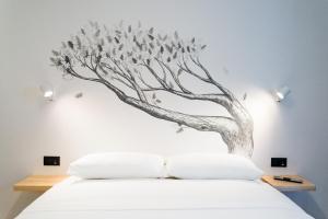 una camera da letto con un murale sull'albero di BOTTASSO17 Guest House a due passi dal mare a Terracina