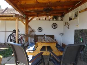 a wooden table and chairs in a patio at Ubytovani Dana Brentnerova in Milovice