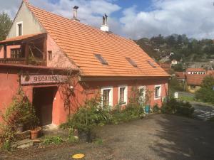 a red building with an orange roof at Decadent Art Club in Český Krumlov