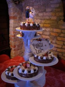 a three tiered cake with a bride and groom on top at Principato Di Ariis in Rivignano