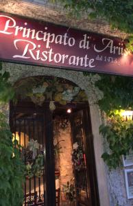 a sign for a restaurant on the side of a building at Principato Di Ariis in Rivignano