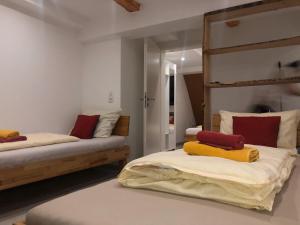 a bedroom with two beds with red and yellow pillows at Dionysos Traube in Rottweil