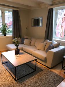 a living room with a couch and a coffee table at Stryn - house by the river in Stryn