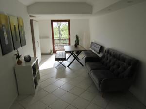 a living room with a couch and a table at Wohlfühlwohnung in Ergolding in Ergolding