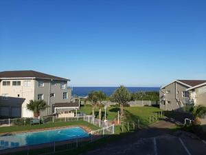 a view of a apartment complex with a swimming pool at Uvongo Chalet 11 in Margate