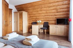 a bedroom with two beds with towels on them at Dom Wypoczynkowy Koliba in Białka Tatrzańska