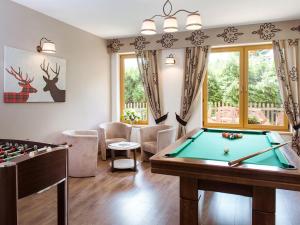 a living room with a pool table and a game room at Dom Wypoczynkowy Koliba in Białka Tatrzanska