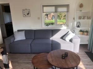 a living room with a couch and a table at Anna in Hollum