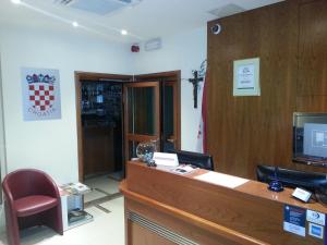 a court room with a reception desk and a cross on the wall at Hotel Croatia in Zagreb