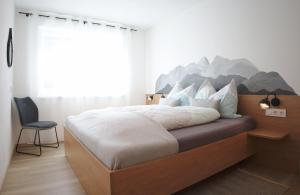 Posteľ alebo postele v izbe v ubytovaní Berg' & Bluamen Appartements Stubai