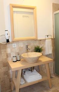 a bathroom with a bowl sink and a mirror at Villamer Alaçatı in Alaçatı +99 photos