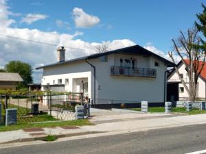 a white house on the side of a street at apartma "happy Scotts" in Starše