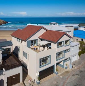 an aerial view of a house with the beach at C Flat Herolds Bay in Herolds Bay