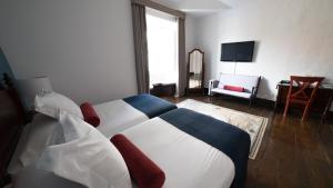 Postel nebo postele na pokoji v ubytování Hotel Aguere